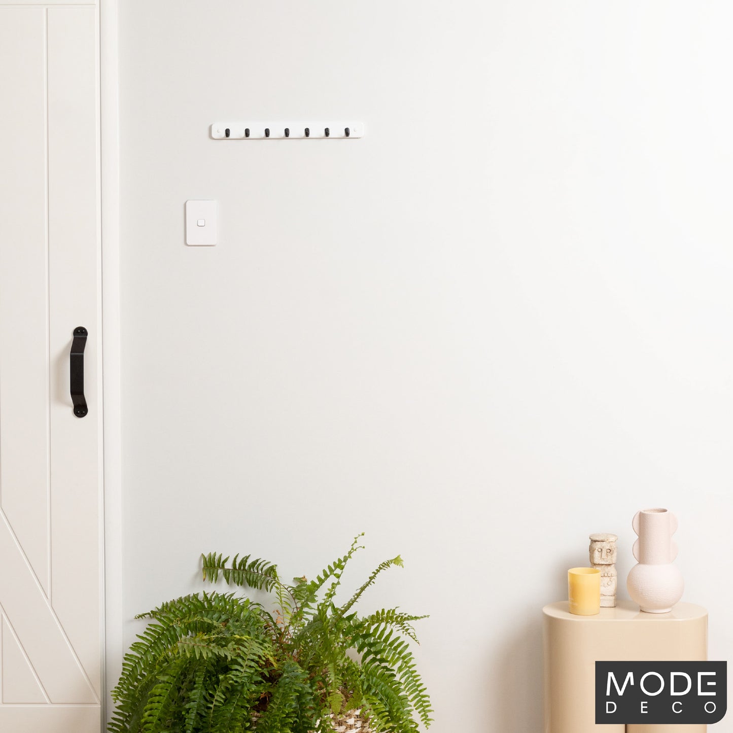 7 Black Hooks on White Board Key Rack